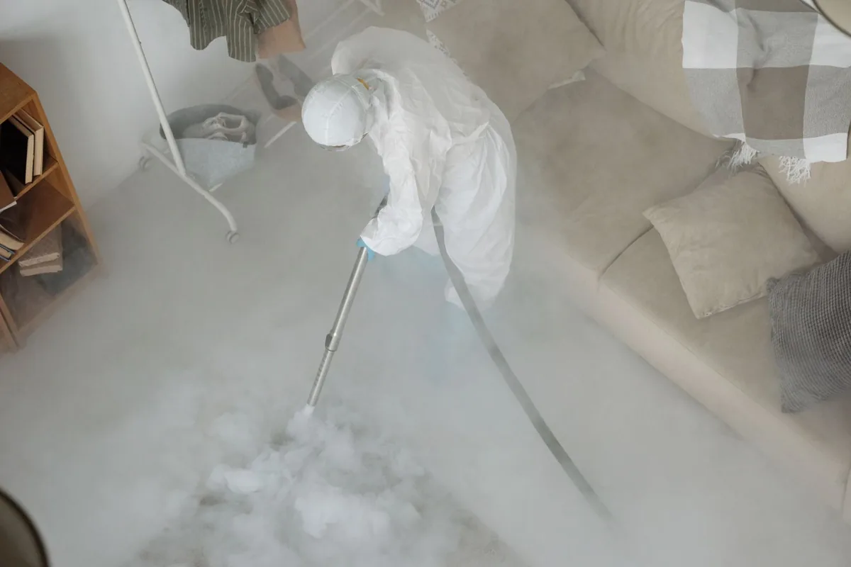 Biohazard cleanup technician in protective equipment, Longboat Key, FL